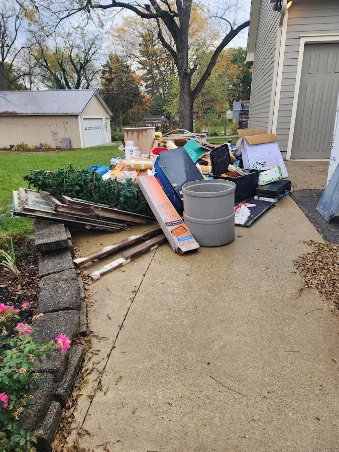 Dumpster being loaded with debris for Estate Cleanout Dumpster Rental in North Platte